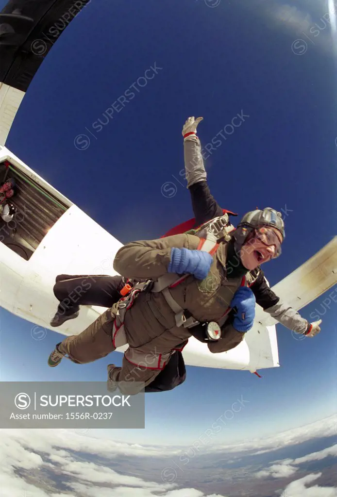 Two people skydiving (fish-eye lens)