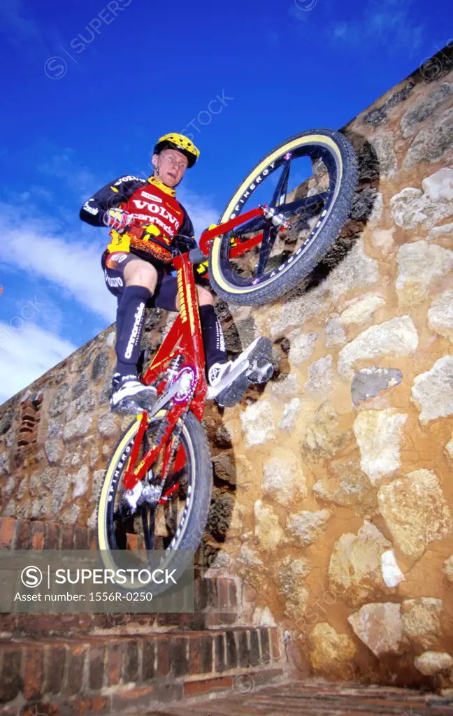 Young adult man performing stunt on bicycle