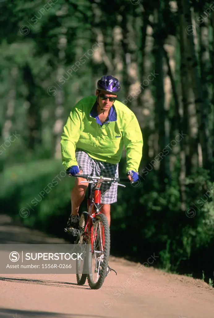Young adult man riding bicycle