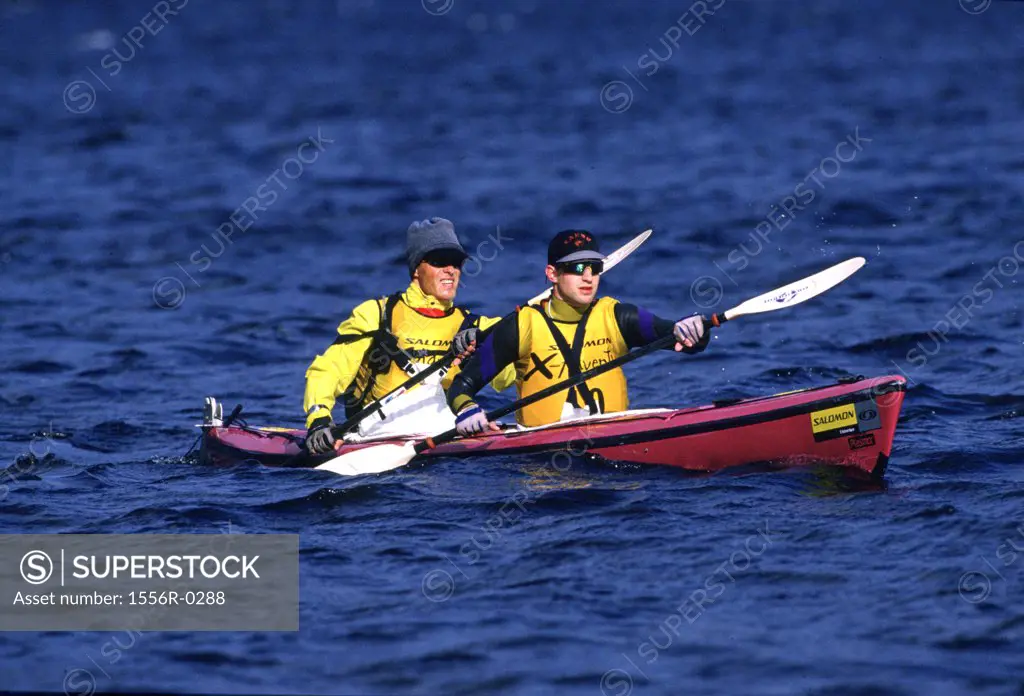 Two young adult men kayaking, Patagonia