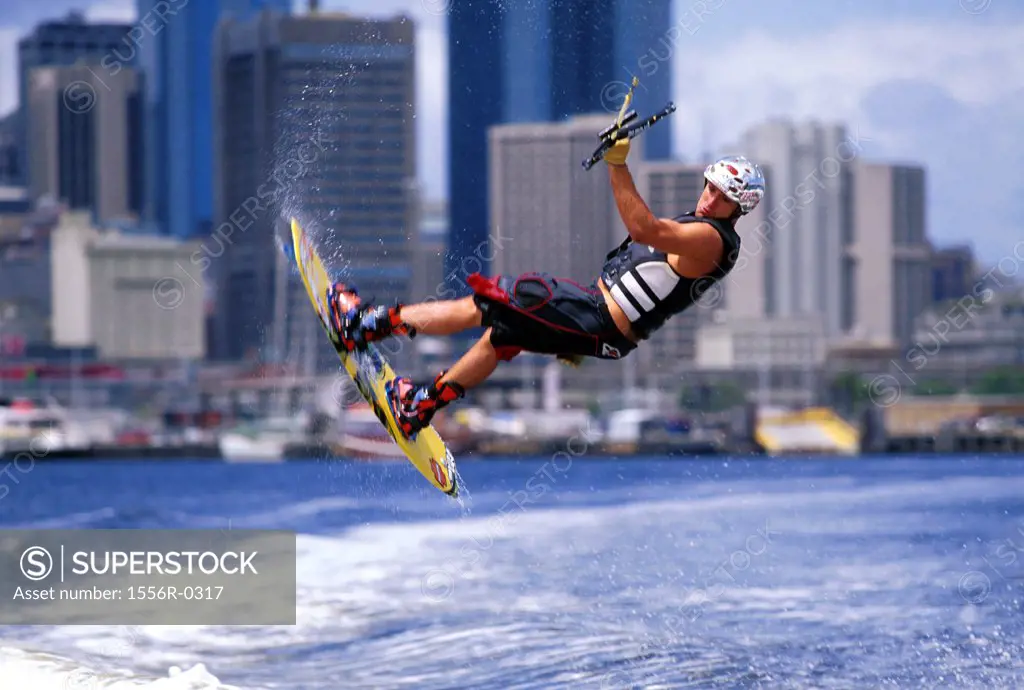 Young adult man wakeboarding, Melbourne, Australia