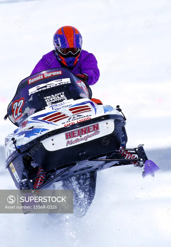 Snowmobiler performing stunt