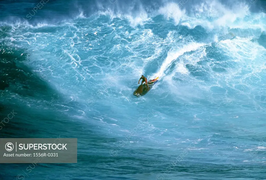 Jet skiing in front of a large wave, Maui, Hawaii, USA