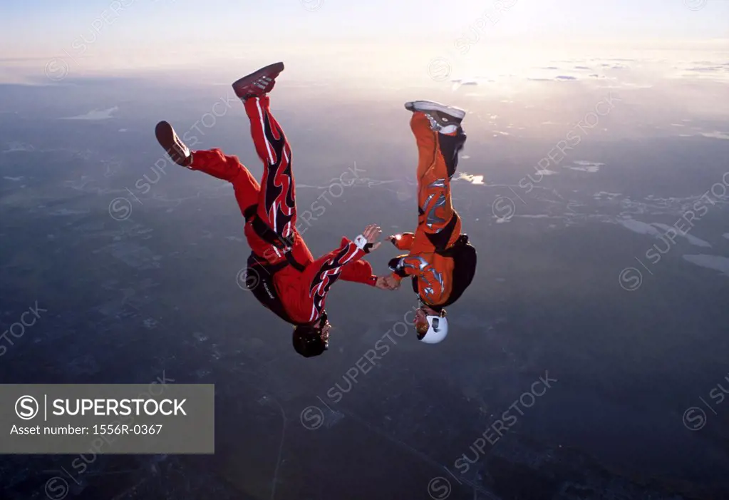 Couple skydiving upside down