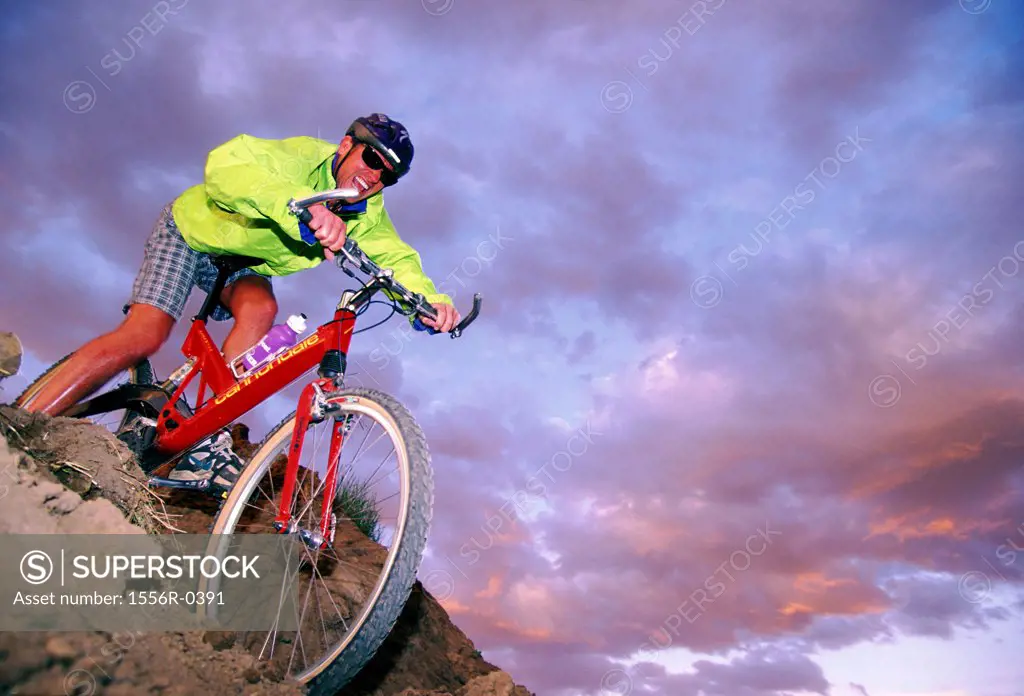 Man mountain biking downhill