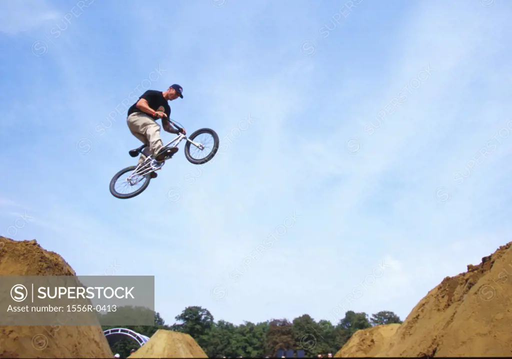 Teenager performing stunt on bicycle