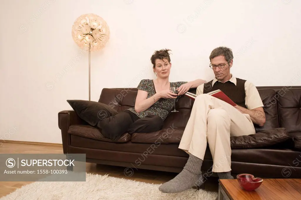 Couch, couple, middle age, man,   Book, reading, woman, bored,   Living rooms, Stehlampe, 30-40 years, 40-50 years, couple, together, side by side, pa...