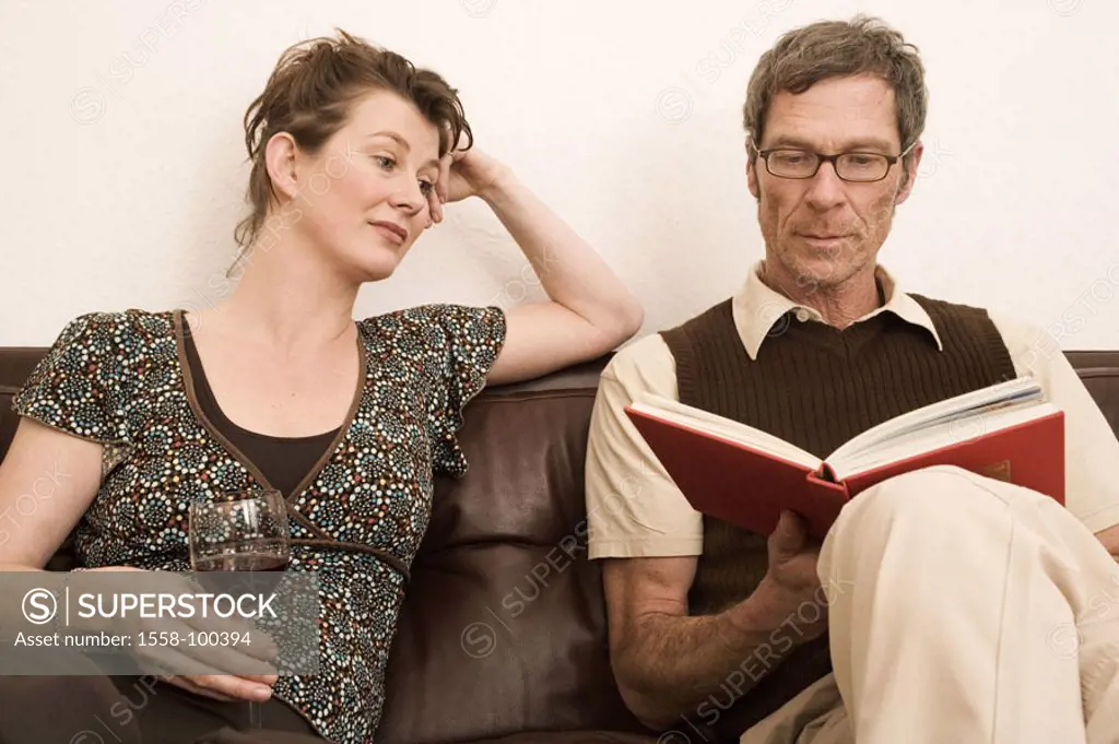 Couch, couple, middle age, man, book,  reading, woman, wine glass,   Living rooms, sofa, 30-40 years, 40-50 years, couple, together, side by side, par...
