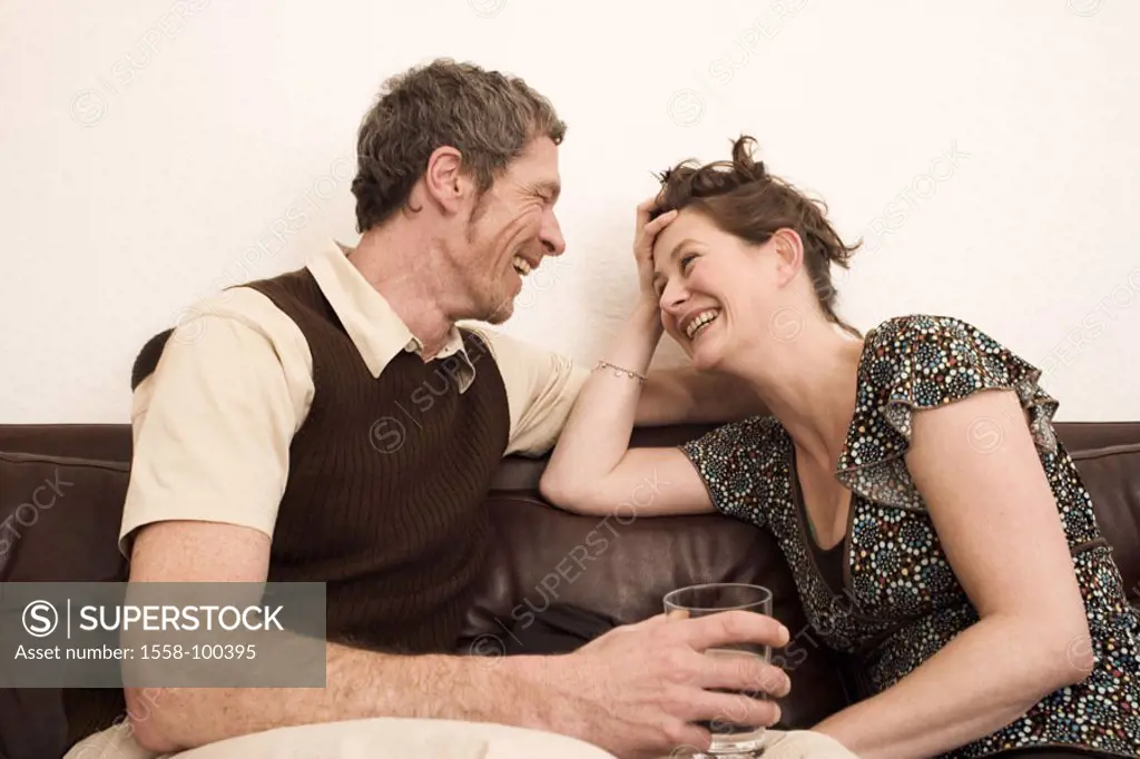 Couch, pair, middle age, conversation,,  laughs, cheerfully, falls in love, gaze contact,  Half portrait,  Living rooms, 30-40 years, 40-50 years, con...