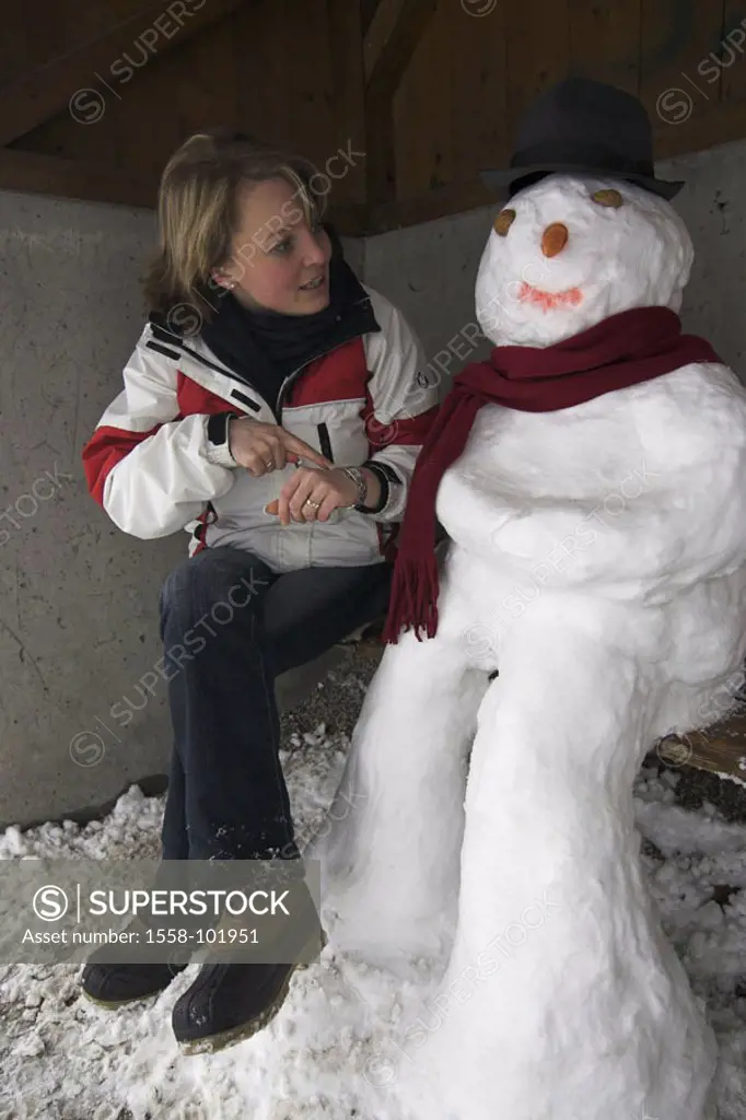 Bus stop, wood bank, snowman, Woman, young, gesture, watch, winters,   20-30 years, blond, winter clothing, sitting, stop, shelters, means of transpor...