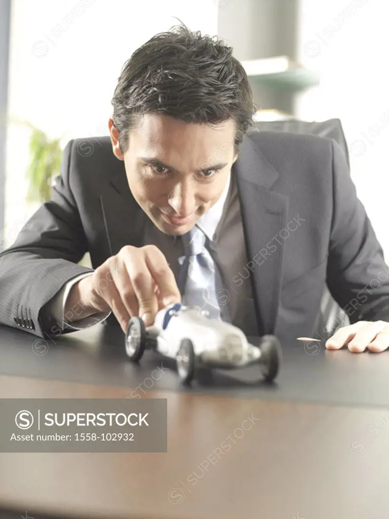 Desk, businessman,  Model racing cars, gesture, smile,   30-40 years, man, playing dream car employee, office worker, toy car, model car, symbol, enth...