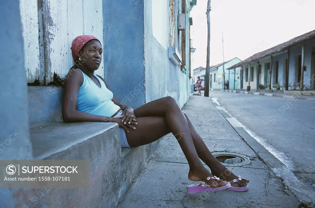 Cuba, Baracoa, center, entrance, woman, sits, waits, no models village, houses, row of houses, natives, release, Central America, Cuban, people of col...