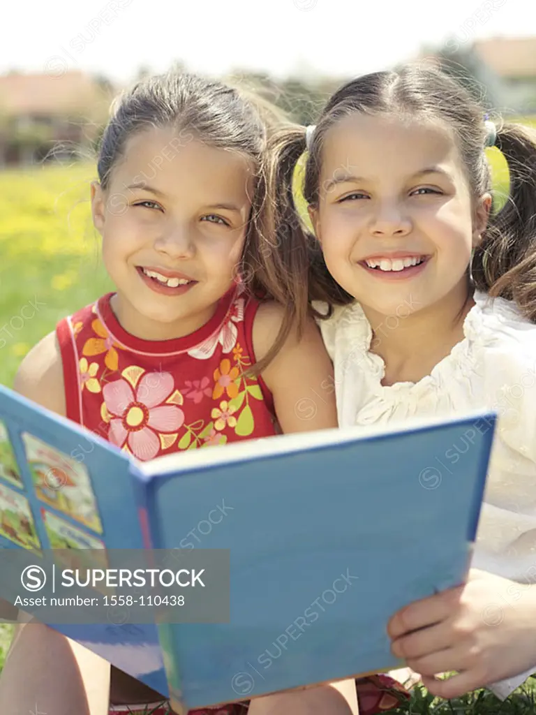 Girls, book, meadow, read sits, portrait, people, child-portrait, children, 9 years, twins, sisters, brunette, friends, cheerfully, happily, smiles, g...