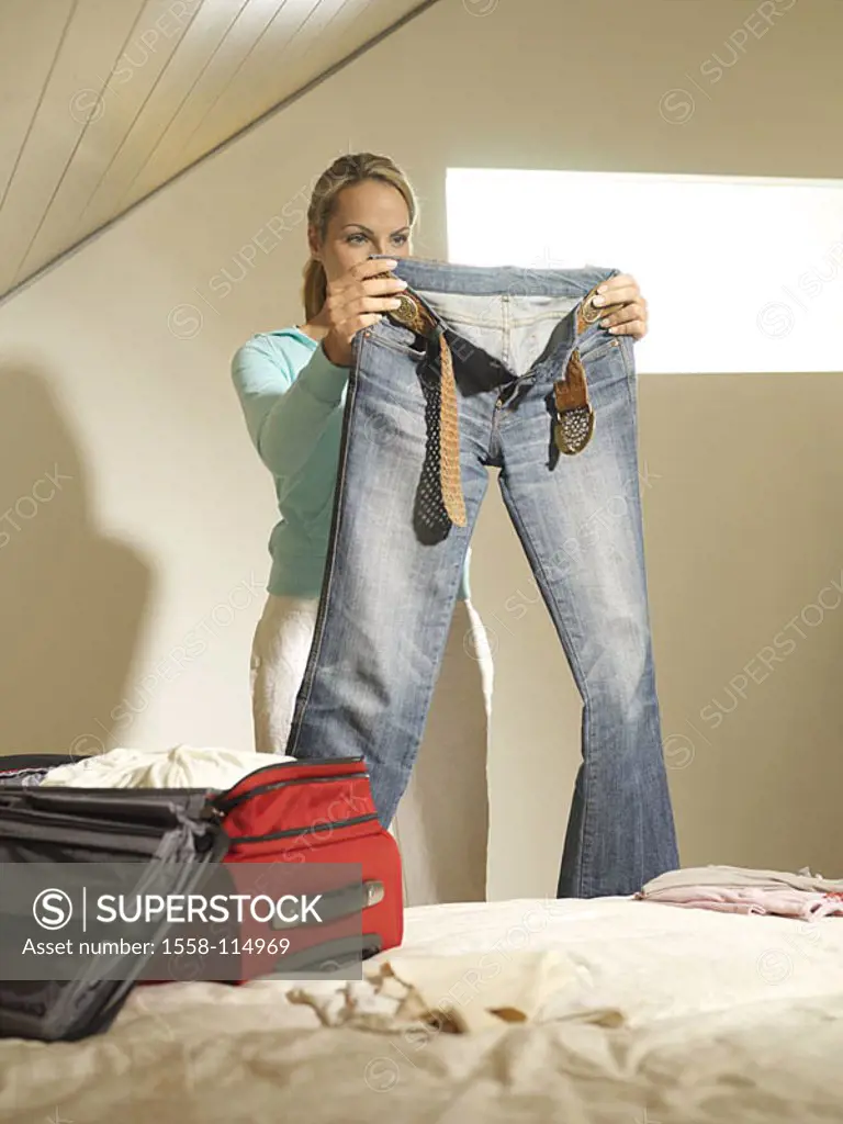 Woman, young, jeans, holds, suitcase-pile, people, 20-30 years, blond, bed, suitcases, traveling bag, packs, squeals, concept, trip, goes on a trip, p...