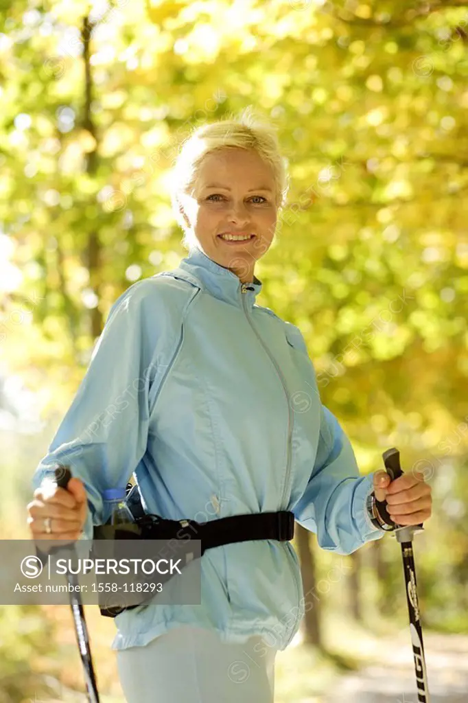 Woman, sport, fitness, Nordic Walking, forest, pause, smiles, gaze camera semi-portrait 20-30 years nature leisure time, activity, hobby, movement, ba...