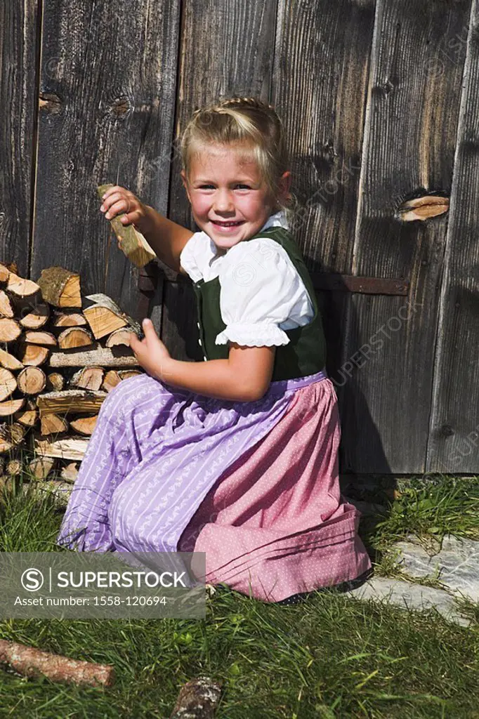 People stack wood-cottage, girls, Dirndel, firewood, series, child 5 years official dress gaze camera happily, cheerfully, joy, childhood freely, natu...