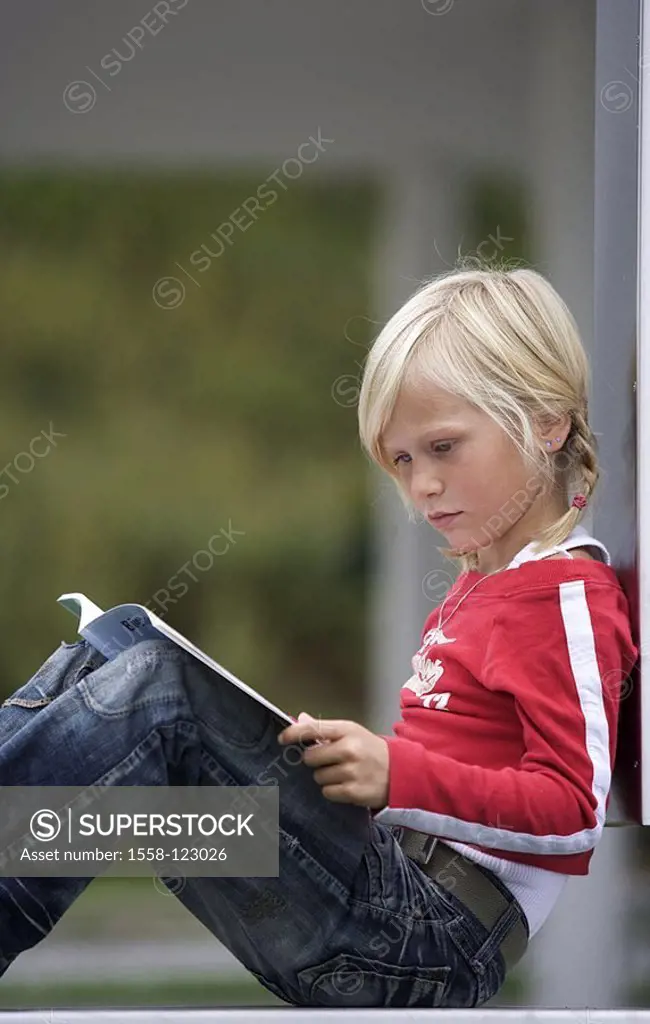 Girls, sits, book, reads, at the side, people, child, schoolchild, 7 years, blond, braids, outside, leisure time, hobby, deepens, concentrates, looks ...