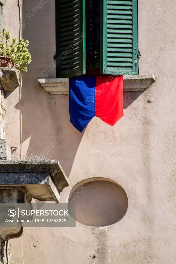 Festival flag and shutter in Amelia, Umbria, Italy,
