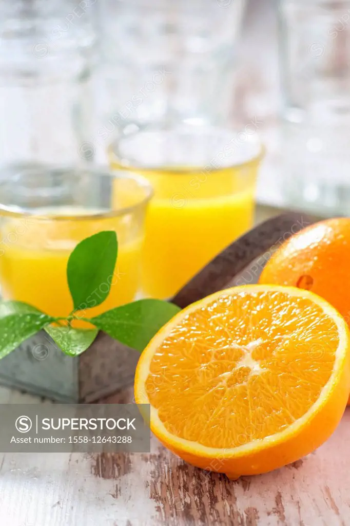 Fresh pressed orange juice and oranges