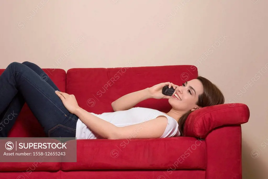 Woman, lie young, couch, telephone,