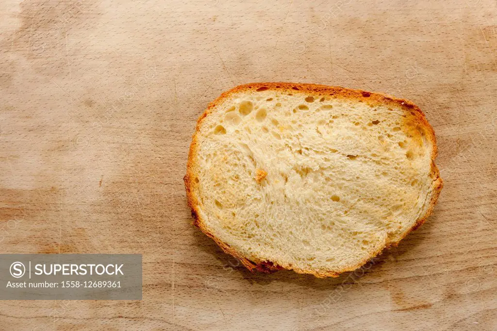 Slice of bread on wooden board