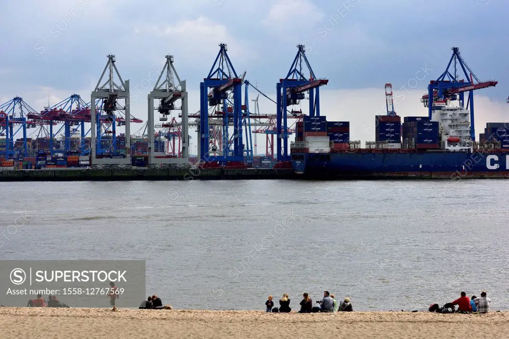 Elbe beach with dock grounds and cranes in the background in the harbour of Hamburg, Germany, Europe