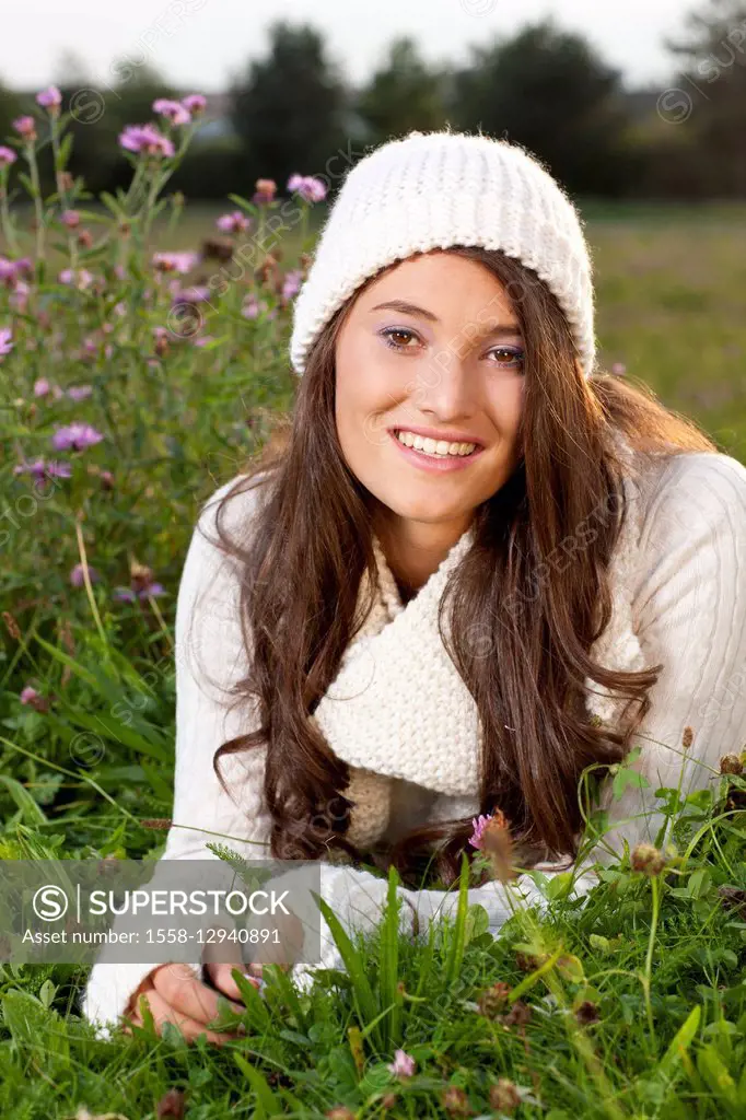 Young dark-haired woman in flower meadow