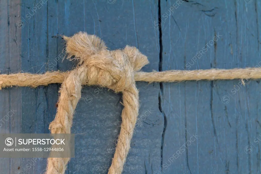 Hemp string knot in front of blue wood