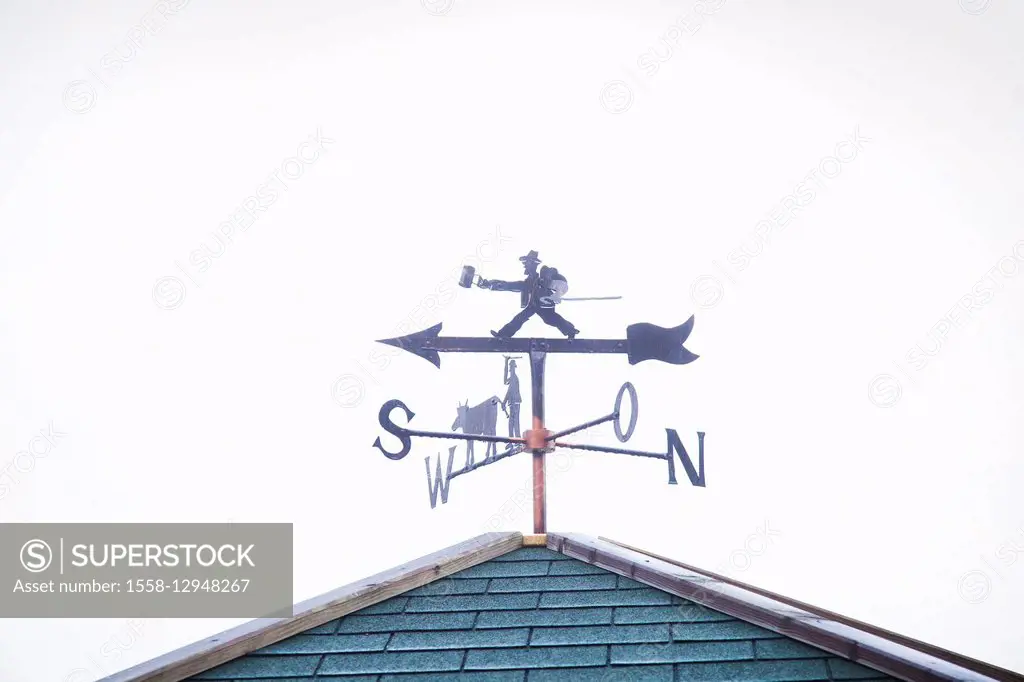 Wind indicator with 'hiker' on a roof