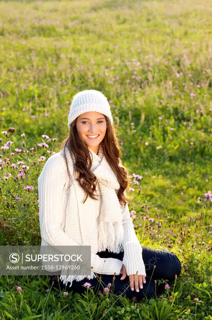 Young dark-haired woman in flower meadow