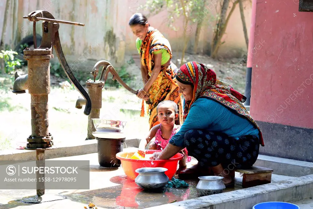 Family wash dishes in Munshiganji, Bangladesh, Asia
