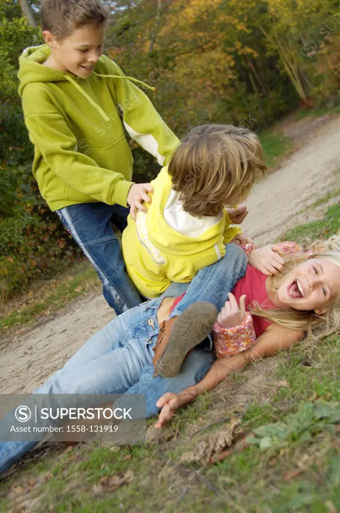Children, girl, boys, forest, play, rants, boisterously, laughs, friends, 8-12 years, friendship, fun, game, forest path, meadow, lie, one on top of t...