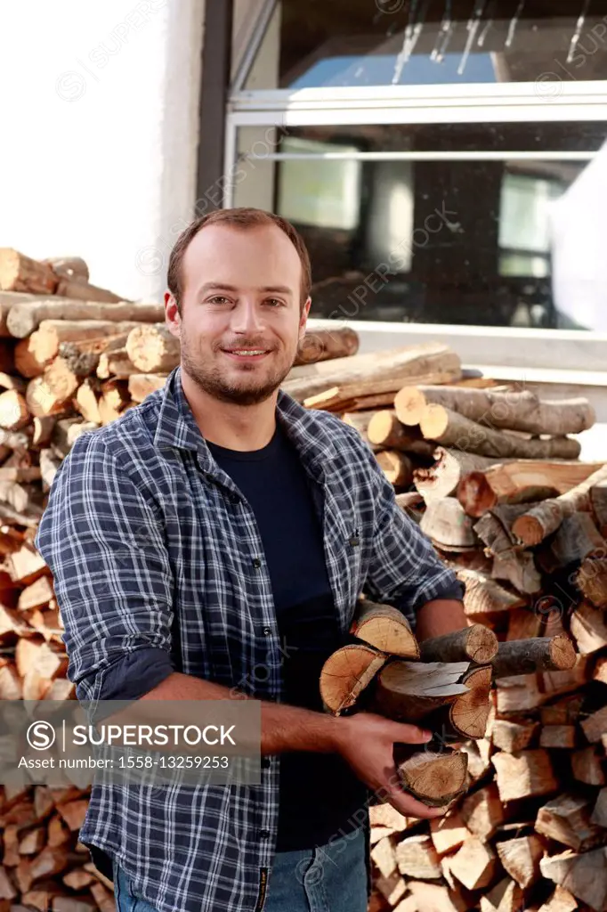 Young man, firewood, carrying, half portrait,