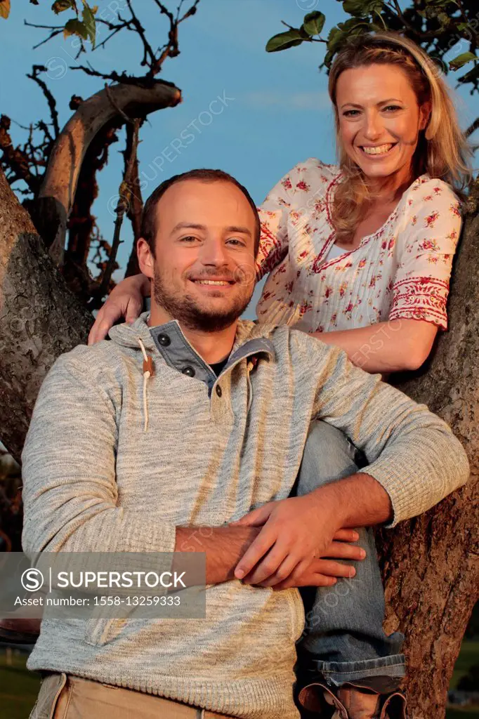 Couple, young, smiling, tree, climbing, half portrait,
