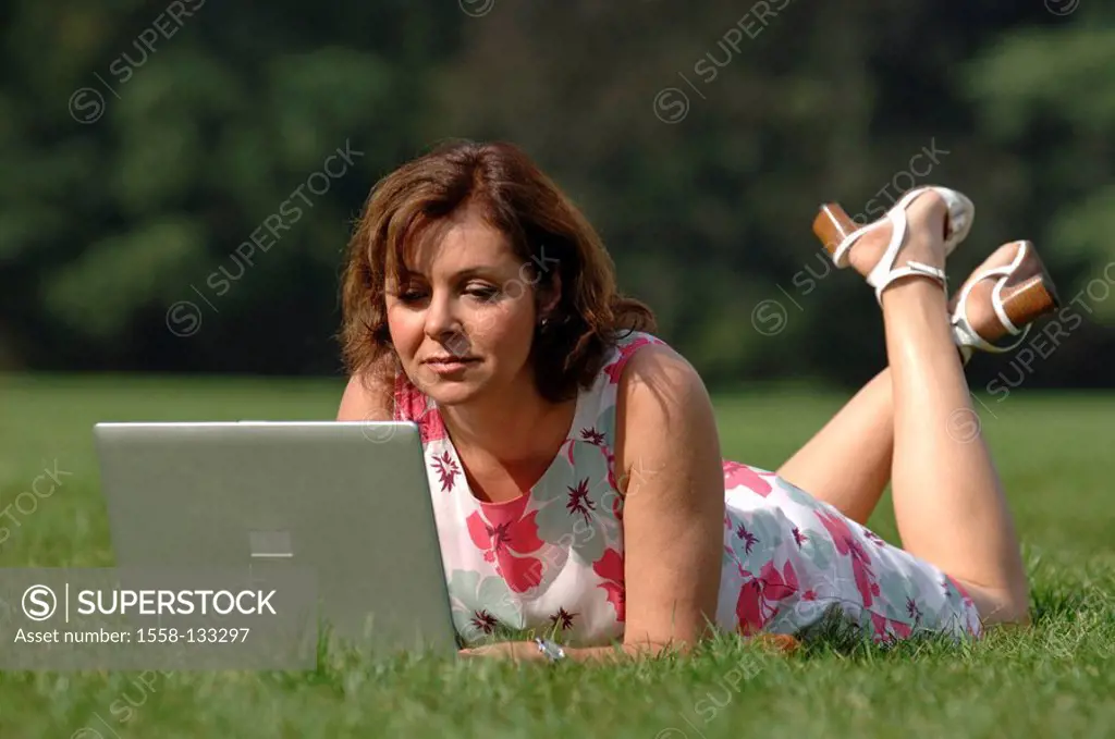 Woman, summer-dress, meadow, lie, Notebook, data input, series, people, 50-60 years, well Age, brunette, computers wearable, work, data processing, In...