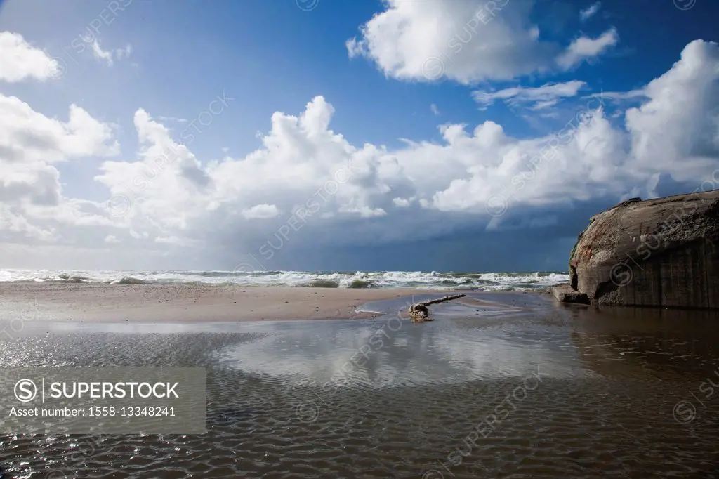 beach of the North Sea with blue heaven and clouds