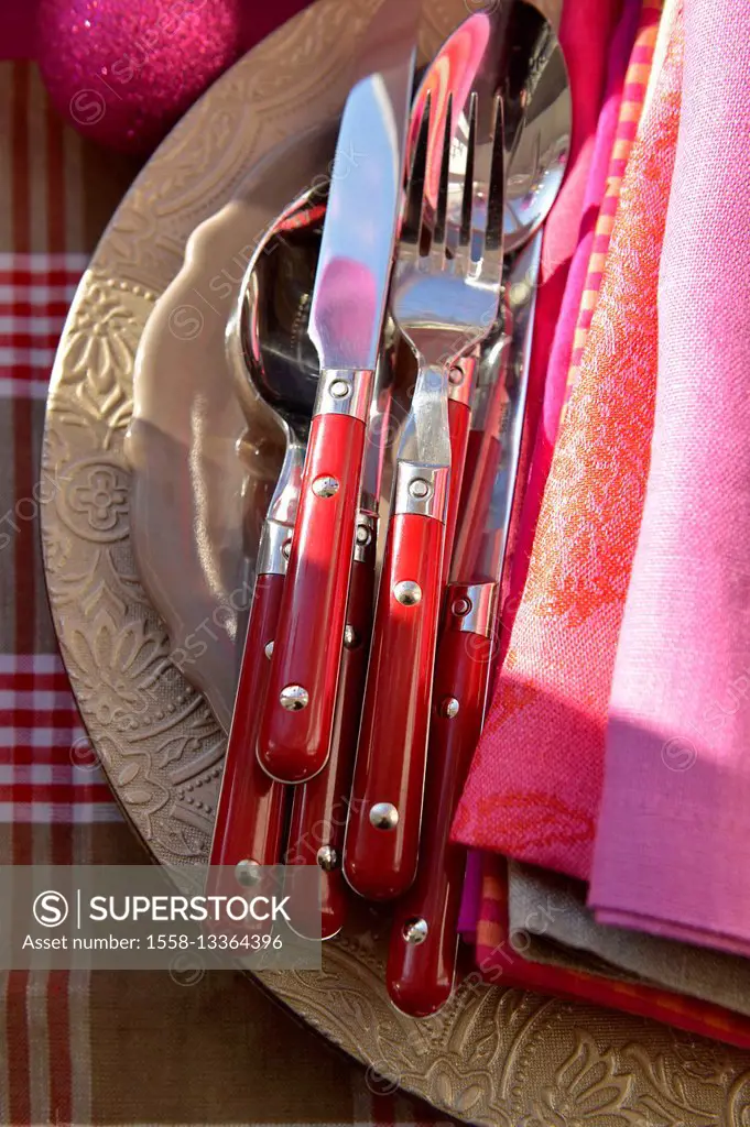 red cutlery with linen napkins