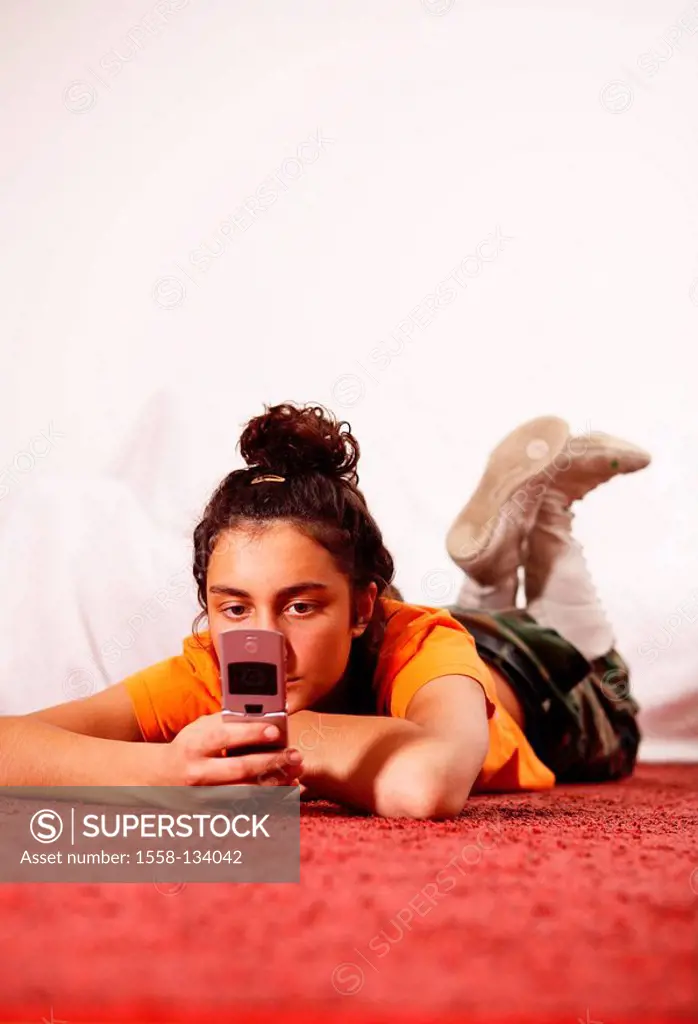 Woman, young, seriously, cell phone, SMS, receives, reading, lie, floor, people, girl, 16-20 years, 20-30 years, brunette, braid, lace-up-boots, tailo...