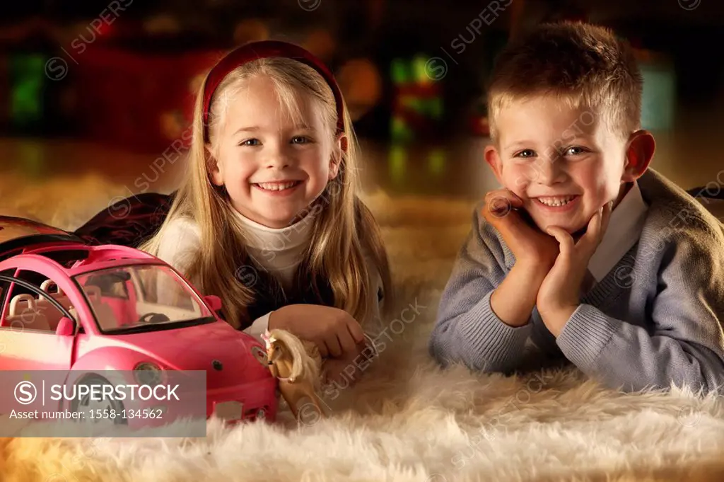 Christmas, siblings, carpet, lie, toy, portrait, background, gifts, fuzziness, series, people, children, 5-7 years, two, girl, boy, smiling, happily, ...
