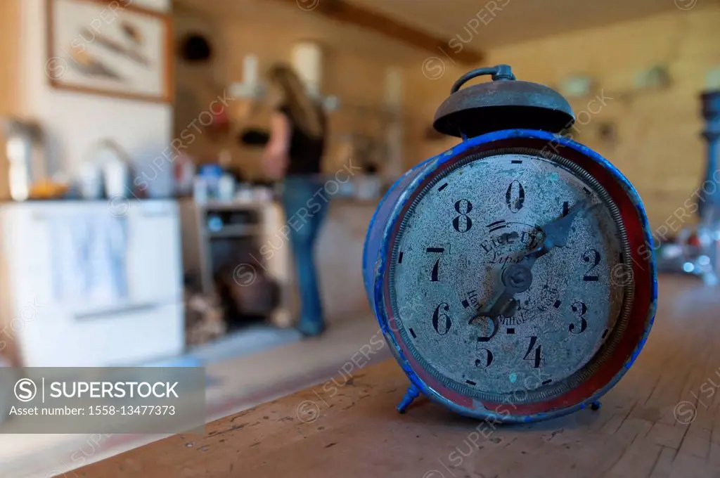 Egg timer and alarm clock with kitchen in the background