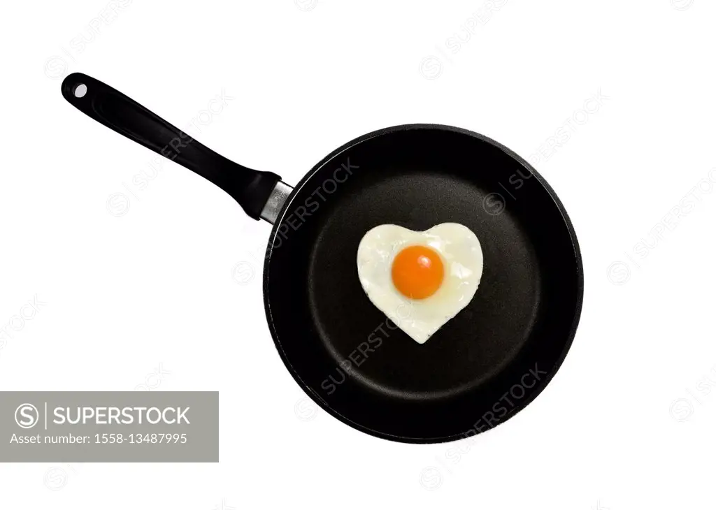 Fried egg in shape of a heart in frying pan