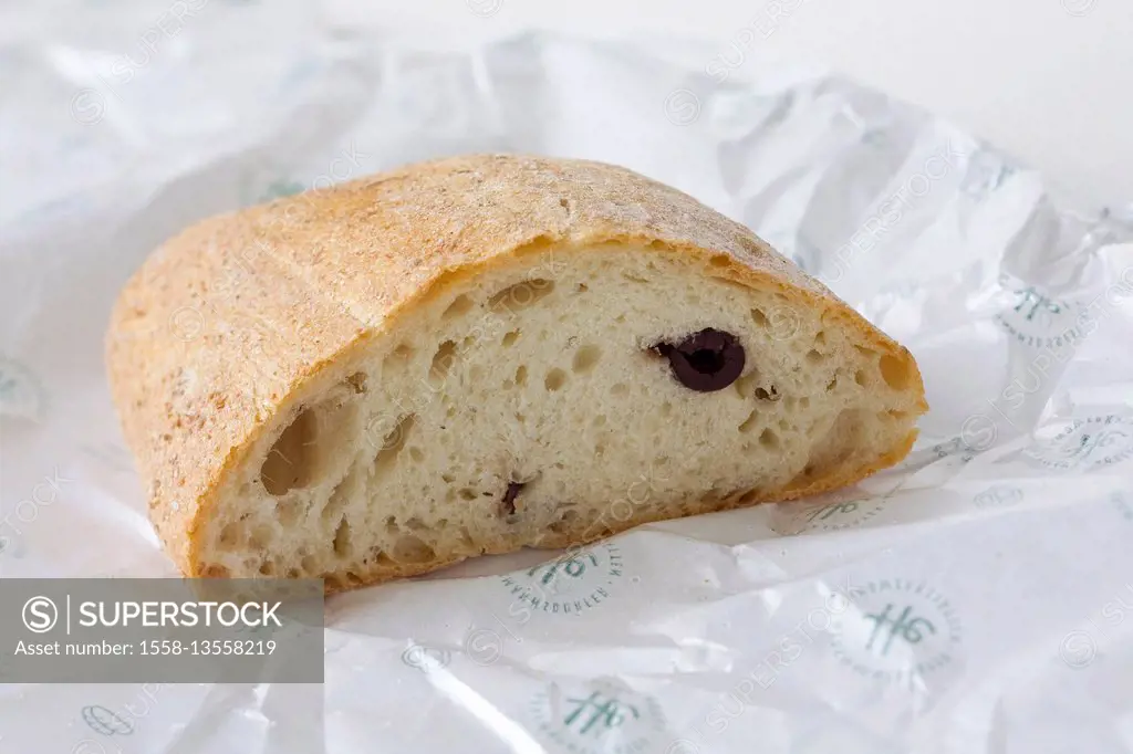 A piece of olive bread on bread paper