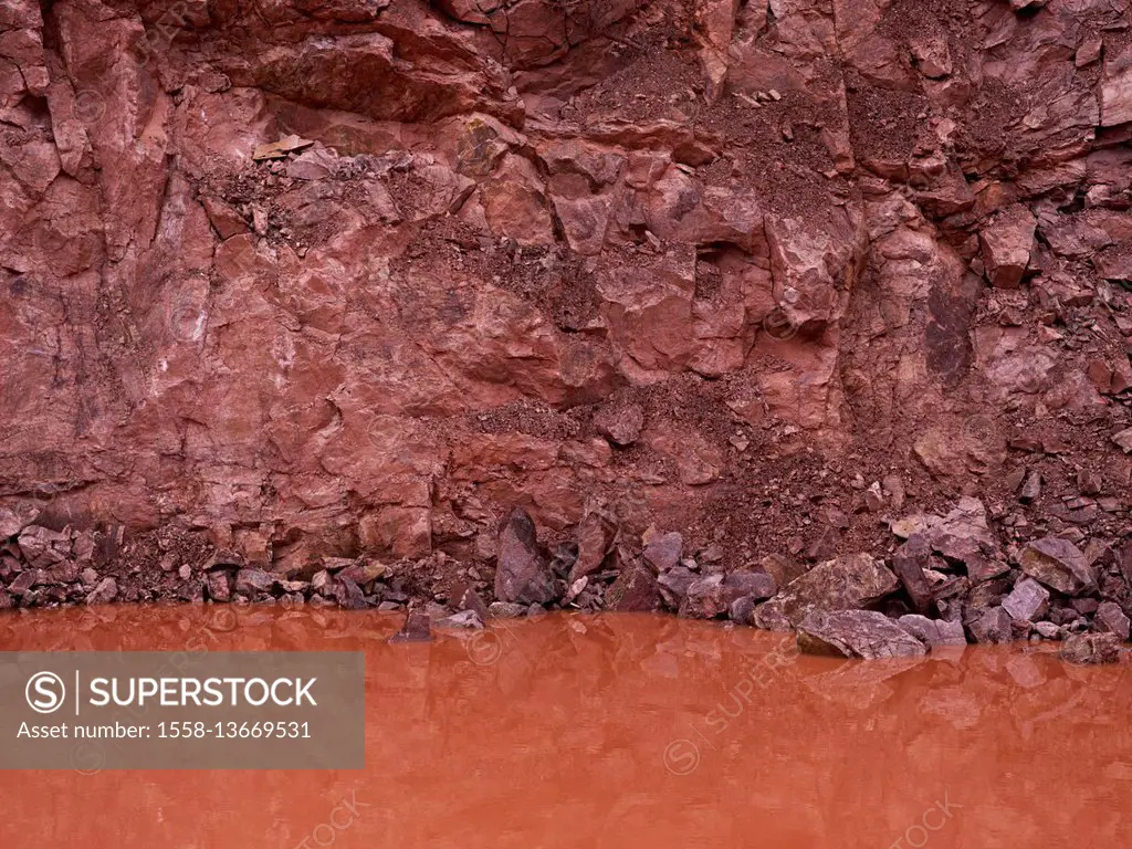 red porphyry with water in a quarry