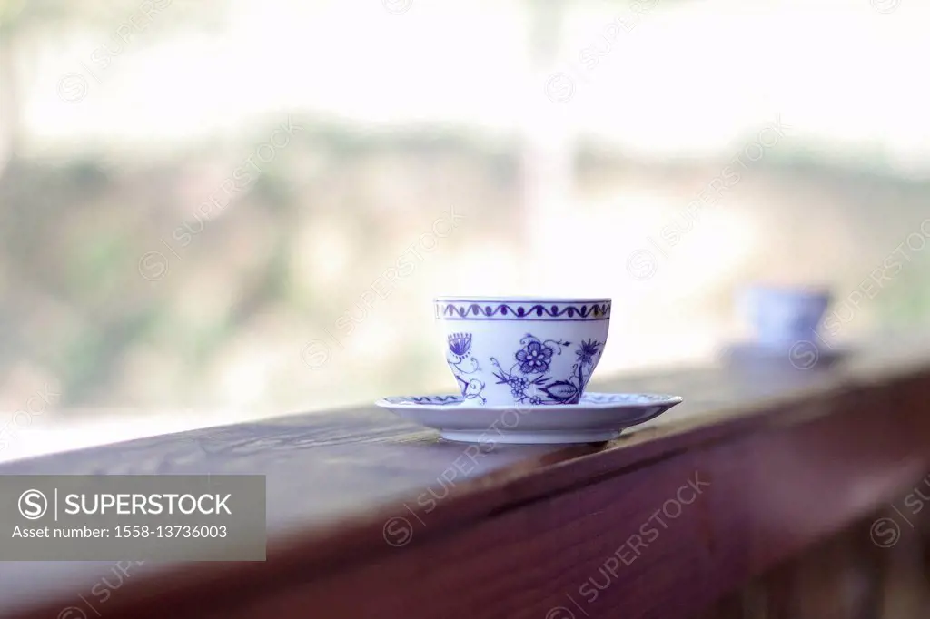 Coffee cup and saucer on balcony