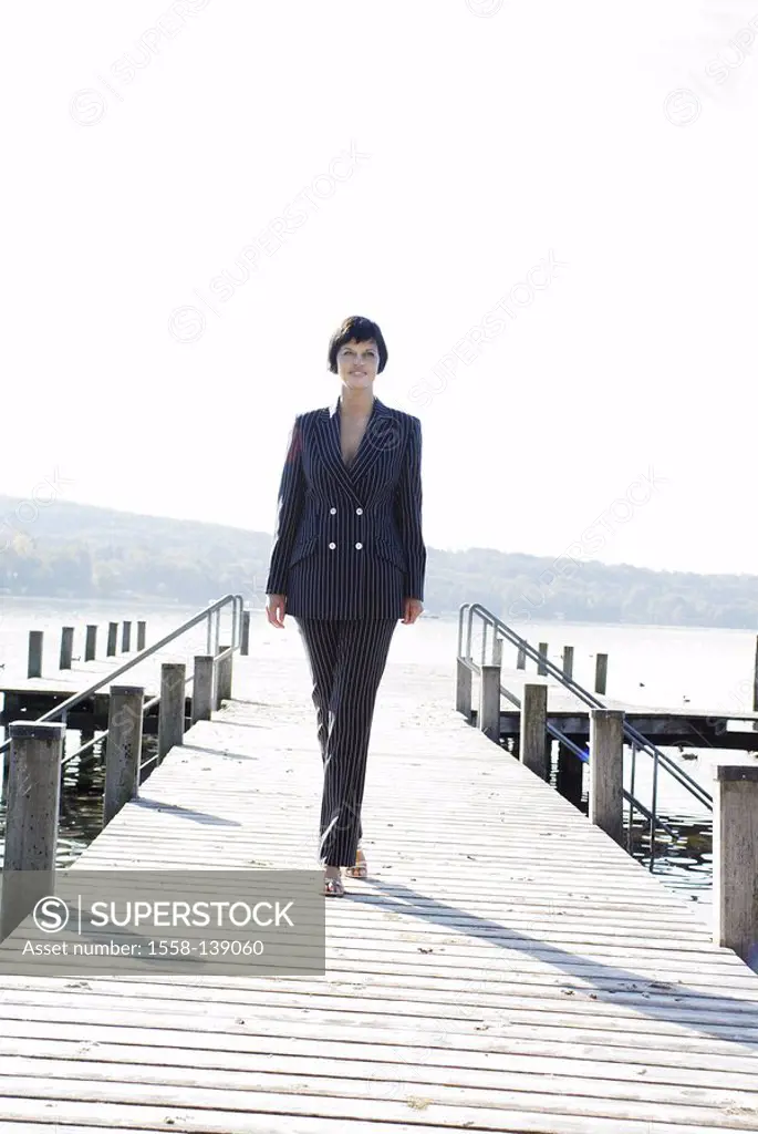 Woman, smiling, going, bridge, lake, series, people, 30-40 years, brunette, pant suit, businesswoman, leisure time, summer, sunny, outside, full-lengt...
