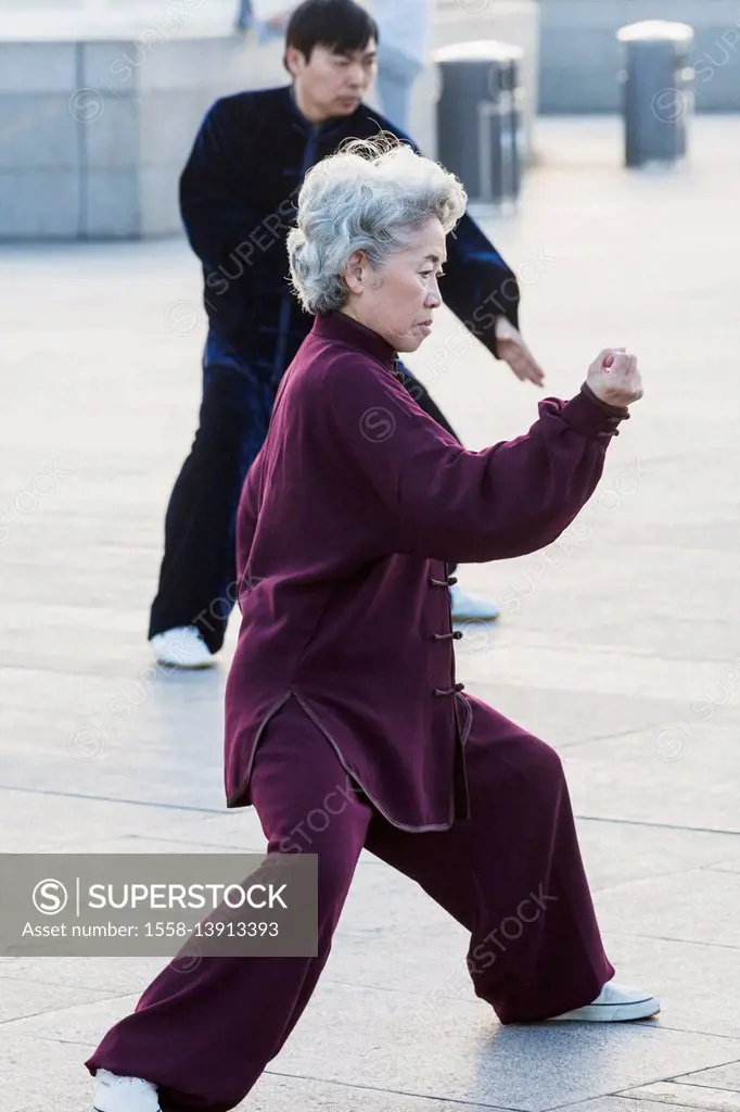 China, Shanghai, The Bund, Elderly Lady Practicing Tai chi