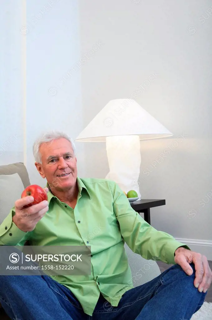 Sits, senior, sofa, apple, holding, gesture, series, people, seniors, man, pensioners, white_haired, fruit, pome, snack, eating, offers, vitamin_rich,...