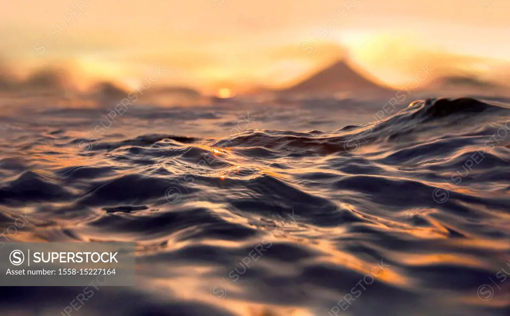 Ocean waves, sunset and Mayon Volcano