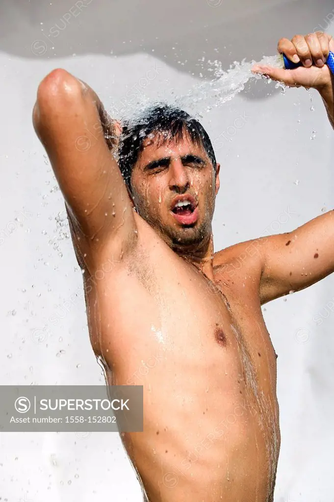 Man, young, hose pipe, takes a shower, outside, semi_portrait,