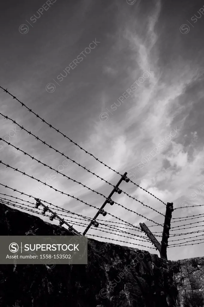 Austria, Mauthausen, concentration camp memorial, encirclement wall, sting wire fence, outside area, clouded sky, s/w,